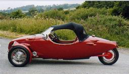 Convertable red small sport cars with three wheels.JPG