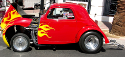 Image of cute small custome car in bright red.PNG