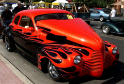 Unique custome car in bright red with black fire patterns.PNG