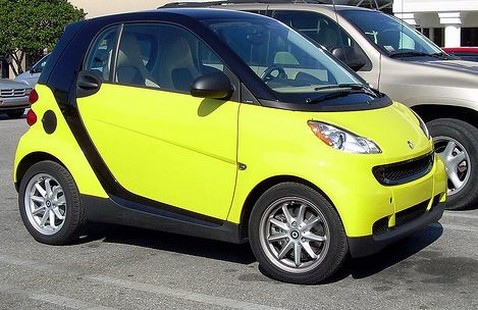 very bright yellow Smart car on the road.jpg